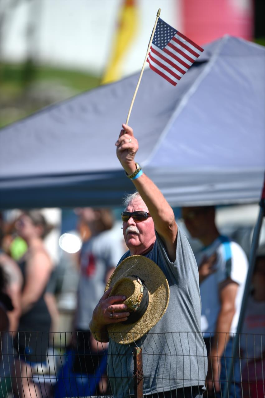 A fan holds an American flag during the national anthem prior to the REV Group Grand Prix Race 1 at Road America Saturday, July 11, 2020 -- Photo by: Chris Owens