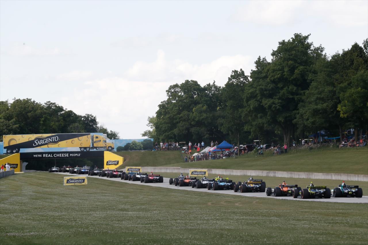 A series of cars roll under the Sargento Bridge during the REV Group Grand Prix Race 1 at Road America Saturday, July 11, 2020 -- Photo by: Chris Owens