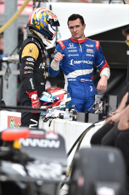 Teammates James Hinchcliffe and Mikhail Aleshin chat along pit lane during the Phoenix Open Test at Phoenix International Raceway -- Photo by: Chris Owens