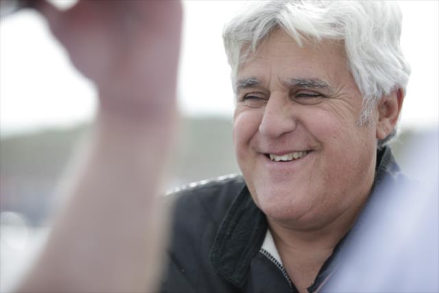 Jay Leno sits along pit lane during a taping of his show at Phoenix International Raceway -- Photo by: Shawn Gritzmacher