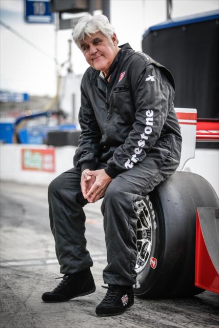 Jay Leno poses for a photograph with his machine on pit lane prior to turning laps at Phoenix International Raceway -- Photo by: Shawn Gritzmacher