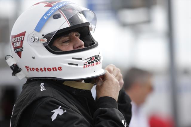 Jay Leno straps on his helmet prior to turning laps at Phoenix International Raceway -- Photo by: Shawn Gritzmacher