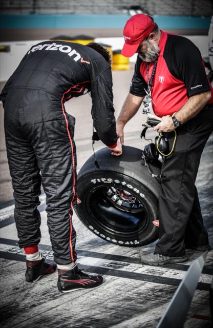 Will Power looks over a Firestone tire with a technician on pit lane during the Phoenix Open Test at Phoenix International Raceway -- Photo by: Shawn Gritzmacher