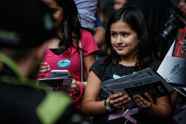 A young fan looks on after getting her autographs during the autograph session in between test sessions at Phoenix International Raceway -- Photo by: Shawn Gritzmacher