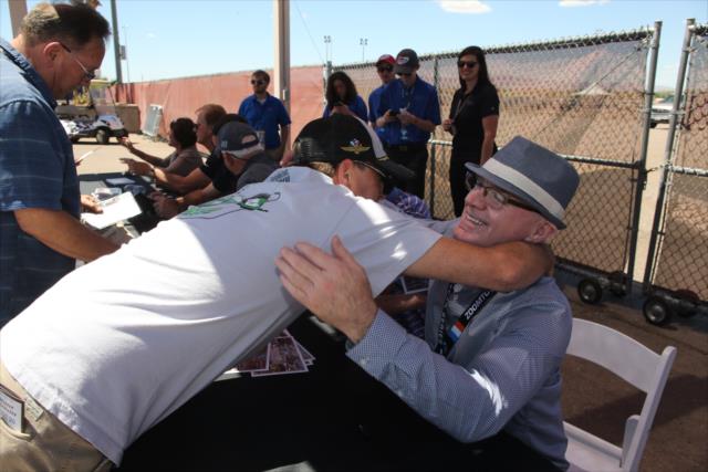 Derek Daly gives a hug to a fan during the legends autograph session at Phoenix Raceway -- Photo by: Richard Dowdy