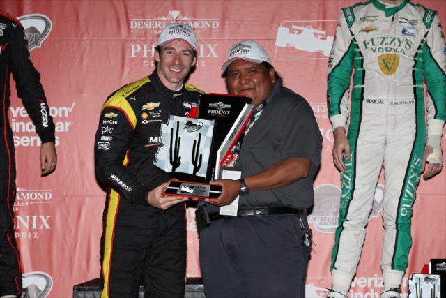 Simon Pagenaud accepts his 1st Place trophy in Victory Circle following the Desert Diamond West Valley Phoenix Grand Prix -- Photo by: Chris Jones