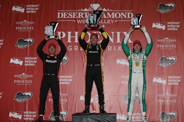 The podium of Simon Pagenaud, Will Power, and JR Hildebrand hoist their trophies in Victory Circle following the Desert Diamond West Valley Phoenix Grand Prix -- Photo by: Chris Jones