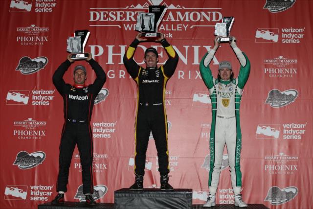 The podium of Simon Pagenaud, Will Power, and JR Hildebrand hoist their trophies in Victory Circle following the Desert Diamond West Valley Phoenix Grand Prix -- Photo by: Chris Jones