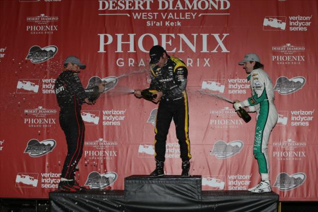 The champagne flies for Simon Pagenaud, Will Power, and JR Hildebrand in Victory Circle following the Desert Diamond West Valley Phoenix Grand Prix -- Photo by: Chris Jones