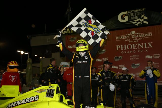 Simon Pagenaud waives the checkered flag in Victory Circle after winning the Desert Diamond West Valley Phoenix Grand Prix -- Photo by: Chris Jones