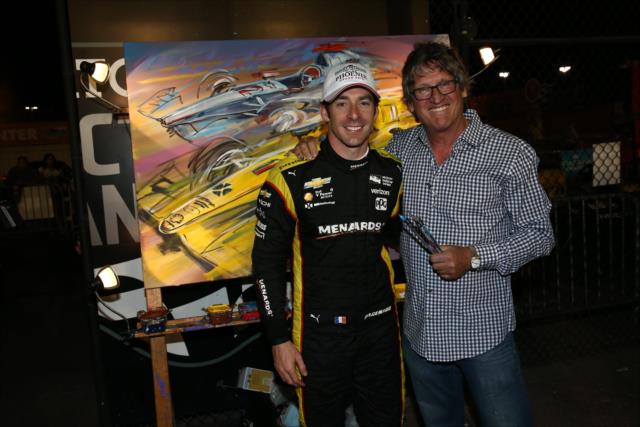 Simon Pagenaud and artist Bill Patterson pose in front of the custom painting following the Desert Diamond West Valley Phoenix Grand Prix at Phoenix Raceway -- Photo by: Chris Jones
