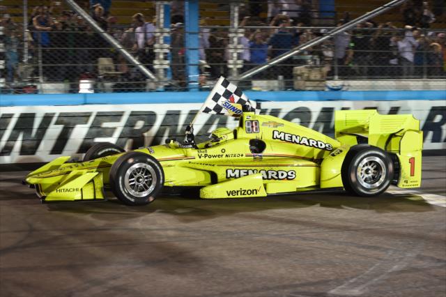 Simon Pagenaud gives the checkered flag a ride after winning the Desert Diamond West Valley Phoenix Grand Prix -- Photo by: Chris Owens