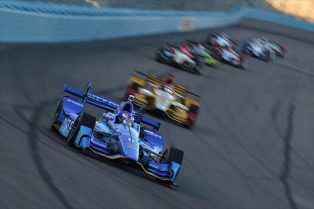 Scott Dixon leads a train of cars into Turn 1 during the Desert Diamond West Valley Phoenix Grand Prix -- Photo by: Chris Owens