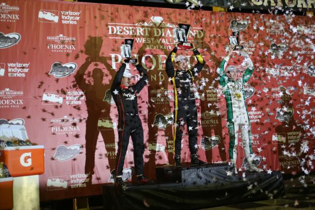 The podium of Simon Pagenaud, Will Power, and JR Hildebrand hoist their trophies in Victory Circle following the Desert Diamond West Valley Phoenix Grand Prix -- Photo by: Richard Dowdy