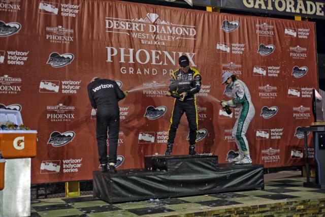 The champagne flies in Victory Circle for Simon Pagenaud, Will Power, and JR Hildebrand following the Desert Diamond West Valley Phoenix Grand Prix -- Photo by: Richard Dowdy