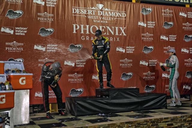 The champagne flies in Victory Circle for Simon Pagenaud, Will Power, and JR Hildebrand following the Desert Diamond West Valley Phoenix Grand Prix -- Photo by: Richard Dowdy