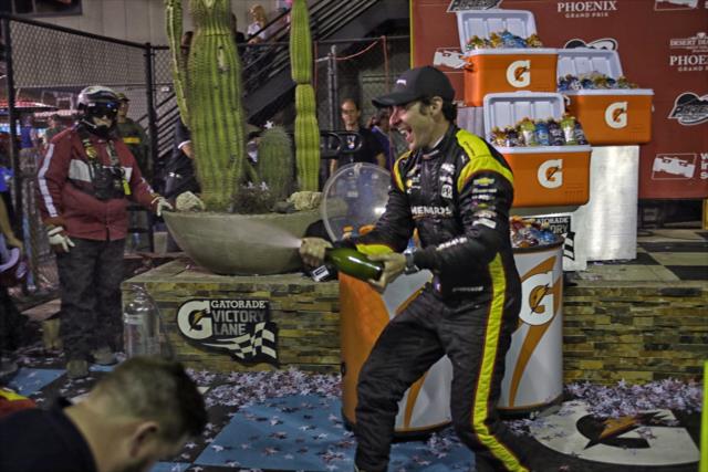 Simon Pagenaud sprays the champagne in Victory Circle after winning the Desert Diamond West Valley Phoenix Grand Prix -- Photo by: Richard Dowdy