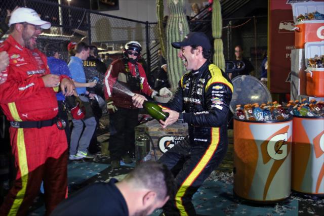 Simon Pagenaud sprays the champagne toward his crew in Victory Circle after winning the Desert Diamond West Valley Phoenix Grand Prix -- Photo by: Richard Dowdy