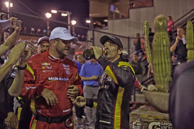 Simon Pagenaud drinks the champagne in Victory Circle after winning the Desert Diamond West Valley Phoenix Grand Prix -- Photo by: Richard Dowdy
