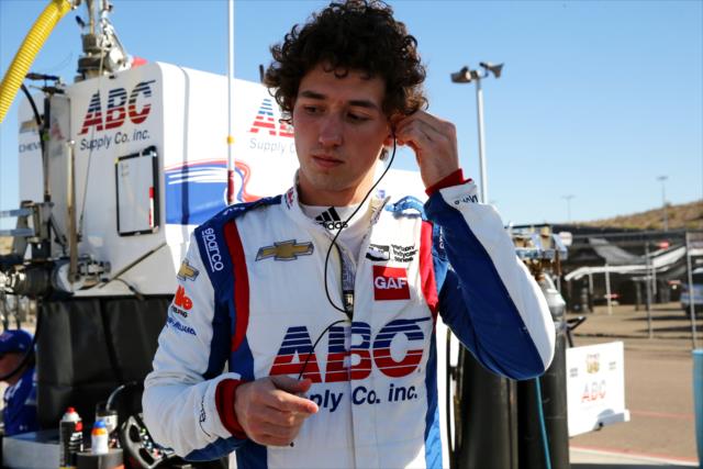 Matheus 'Matt' Leist sets his earpieces on pit lane prior to track activity during the rookie oval test at ISM Raceway -- Photo by: Chris Jones