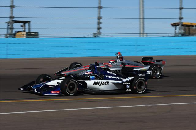 Takuma Sato and Will Power go wheel-to-wheel through Turn 4 during the afternoon open test session at ISM Raceway -- Photo by: Chris Jones