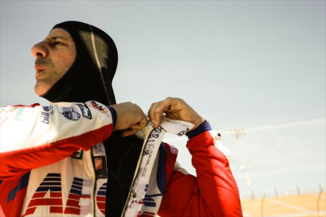 Tony Kanaan adjusts his firesuit prior to the start of the afternoon open test session at ISM Raceway -- Photo by: Shawn Gritzmacher