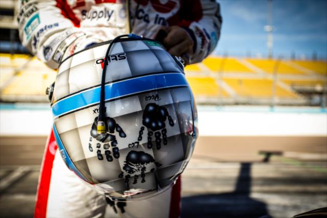 Tony Kanaan preps his helmet along pit lane prior to the afternoon open test session at ISM Raceway -- Photo by: Shawn Gritzmacher