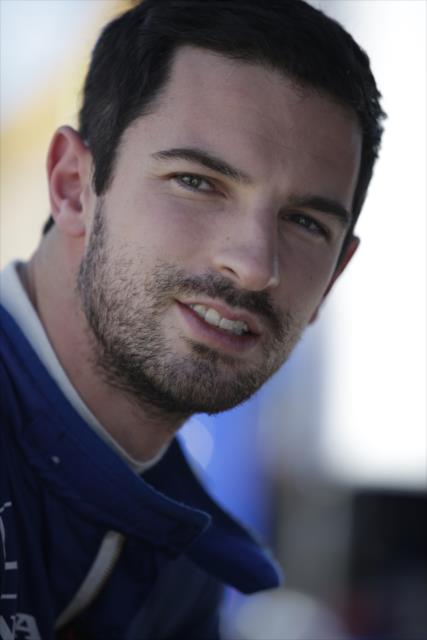 Alexander Rossi waits along pit lane prior to the start of the afternoon open test session at ISM Raceway -- Photo by: Shawn Gritzmacher