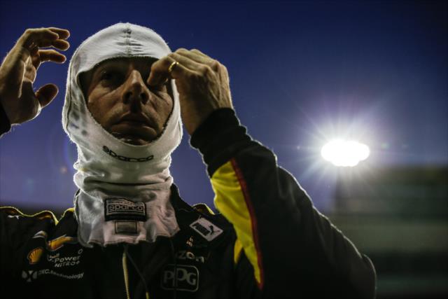 Simon Pagenaud adjusts his balaclava on pit lane during the evening open test session at ISM Raceway -- Photo by: Shawn Gritzmacher