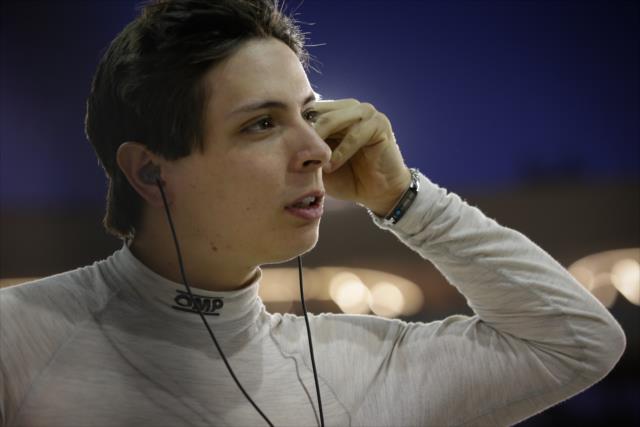 Gabby Chaves sets his earpieces along pit lane during the evening open test session at ISM Raceway -- Photo by: Shawn Gritzmacher