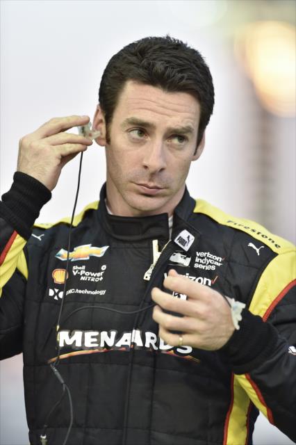 Simon Pagenaud sets his earpieces along pit lane during the evening test session at ISM Raceway -- Photo by: Chris Owens