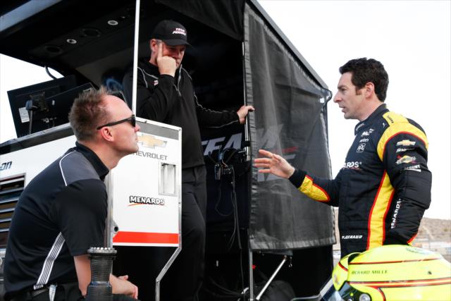 Simon Pagenaud chats with chief engineer Ben Bretzman on pit lane during the afternoon open test session at ISM Raceway -- Photo by: Joe Skibinski