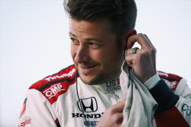 Marco Andretti sets his earpieces along pit lane prior to the evening open test session at ISM Raceway -- Photo by: Joe Skibinski