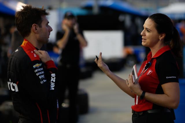 Will Power chats with Firestone's Cara Adams along pit lane during the evening open test session at ISM Raceway -- Photo by: Joe Skibinski
