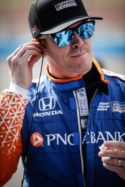 Scott Dixon sets his earpieces along pit lane prior to the start of the evening test session at ISM Raceway -- Photo by: Shawn Gritzmacher