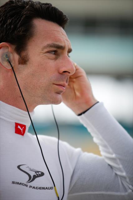 Simon Pagenaud sets his earpieces along pit lane prior to the start of the evening test session at ISM Raceway -- Photo by: Shawn Gritzmacher