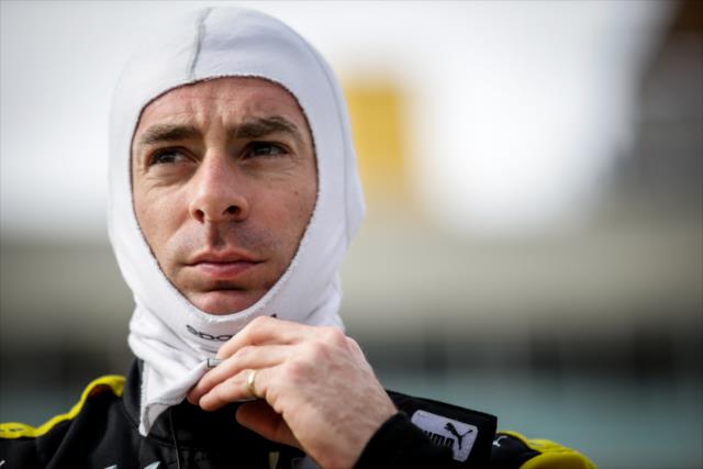 Simon Pagenaud adjusts his balaclava along pit lane prior to the start of the evening test session at ISM Raceway -- Photo by: Shawn Gritzmacher