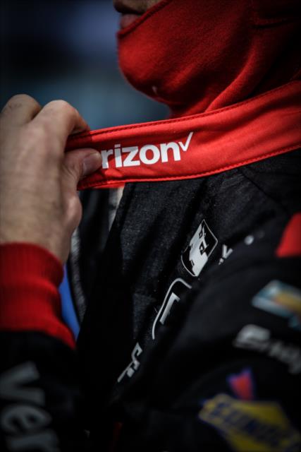 Will Power adjusts his firesuit along pit lane prior to the start of the evening test session at ISM Raceway -- Photo by: Shawn Gritzmacher