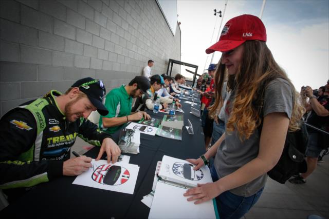 Charlie Kimball signs an autograph during the autograph session at ISM Raceway -- Photo by: Shawn Gritzmacher