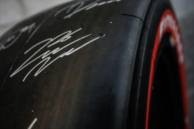 A signed Firestone tire makes its rounds though the autograph session at ISM Raceway -- Photo by: Shawn Gritzmacher