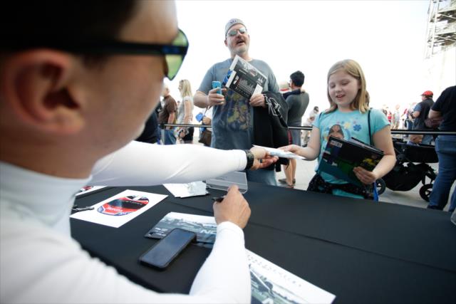 A young fans gets an autograph from Graham Rahal during the autograph session at ISM Raceway -- Photo by: Shawn Gritzmacher