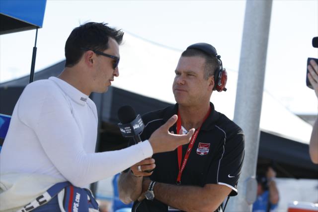 Graham Rahal chats with Jake Query from the Advance Auto Parts INDYCAR Radio Network on pit lane during the afternoon test session at ISM Raceway -- Photo by: Joe Skibinski