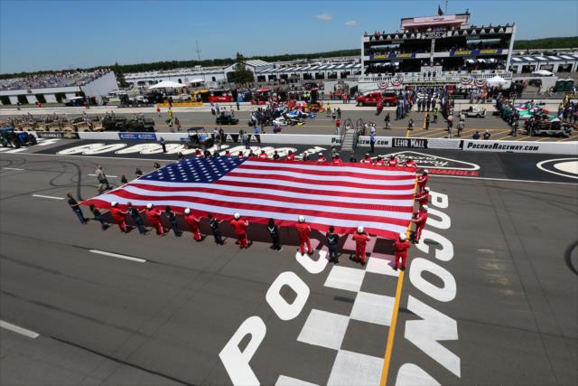 The American Flag is displayed for the National Anthem during pre-race festivities for the Pocono INDYCAR 500 at Pocono Raceway -- Photo by: Bret Kelley