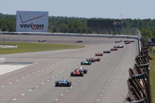 The field streams into Turn 1 during the Pocono INDYCAR 500 -- Photo by: Bret Kelley