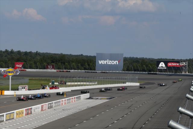 Cars stream out of pit lane to start the evening practice for the ABC Supply 500 at Pocono Raceway -- Photo by: Chris Jones