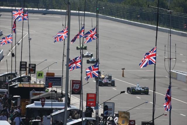 United Kingdom flags fly along pit lane at the start practice for the ABC Supply 500 at Pocono Raceway -- Photo by: Chris Jones