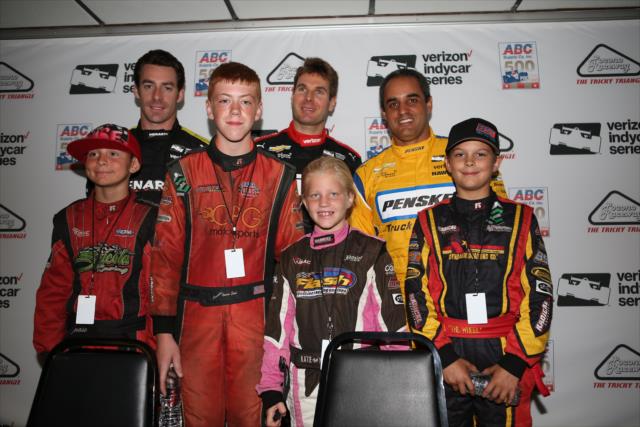 Simon Pagenaud, Will Power and Juan Pablo Montoya pose with young quarter midget races following a press conference at Pocono Raceway -- Photo by: Chris Jones