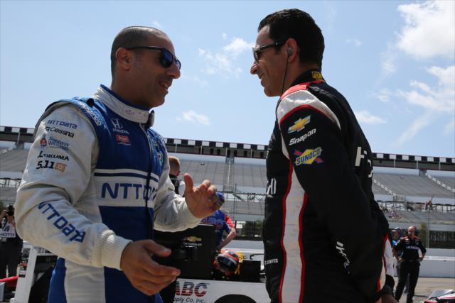 Veterans Tony Kanaan and Helio Castroneves chat on pit lane prior to qualifications for the ABC Supply 500 at Pocono Raceway -- Photo by: Chris Jones