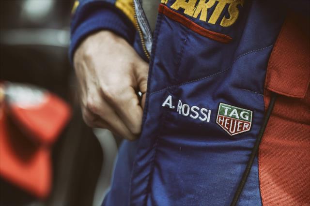 Alexander Rossi zips up his firesuit along pit lane prior to his qualification attempt for the ABC Supply 500 at Pocono Raceway -- Photo by: Chris Owens