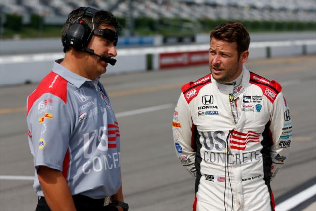Marco Andretti chats with a crewman on pit lane prior to practice for the ABC Supply 500 at Pocono Raceway -- Photo by: Joe Skibinski